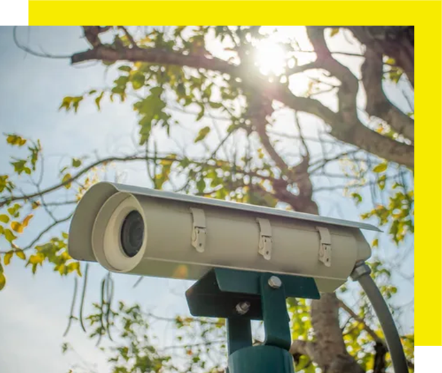 A camera is sitting on top of a pole.